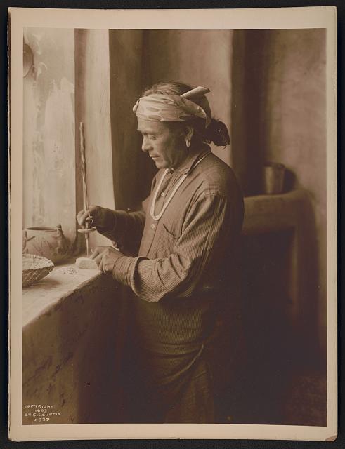 Zuni Indian bead worker drilling holes in beads. Edward S. Curtis, photographer, 1903. Retrieved from Prints and Photographs Division, Library of Congress.
