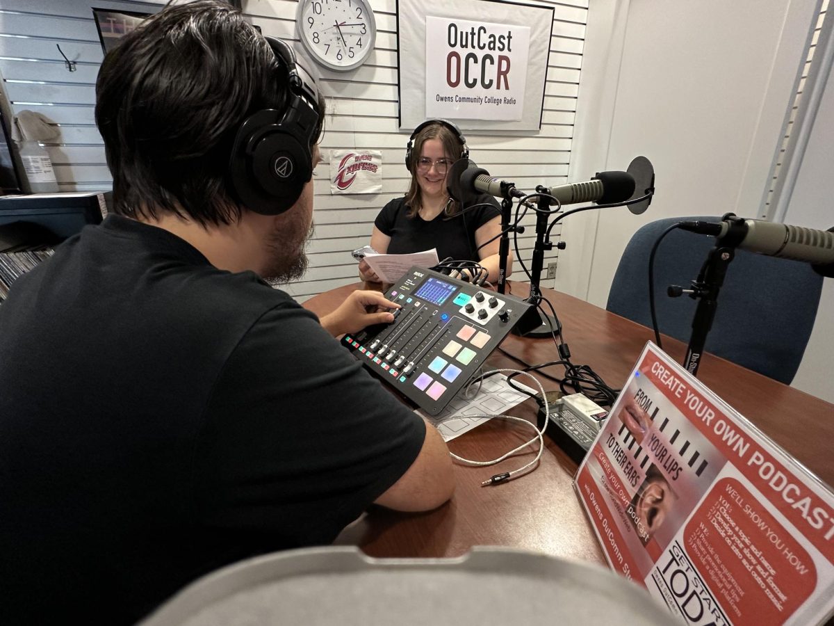 Studio administrator and audio recording engineer Russ Gronbach (left) assists podcast host Hailey Creps (right) as she engages with an industry professional guest via phone.