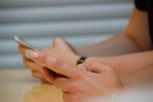 Individual doom-scrolling on social media.  Retrieved from Pixabay.