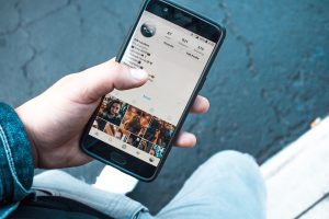 Social media user on his phone. Retrieved from Pixabay.