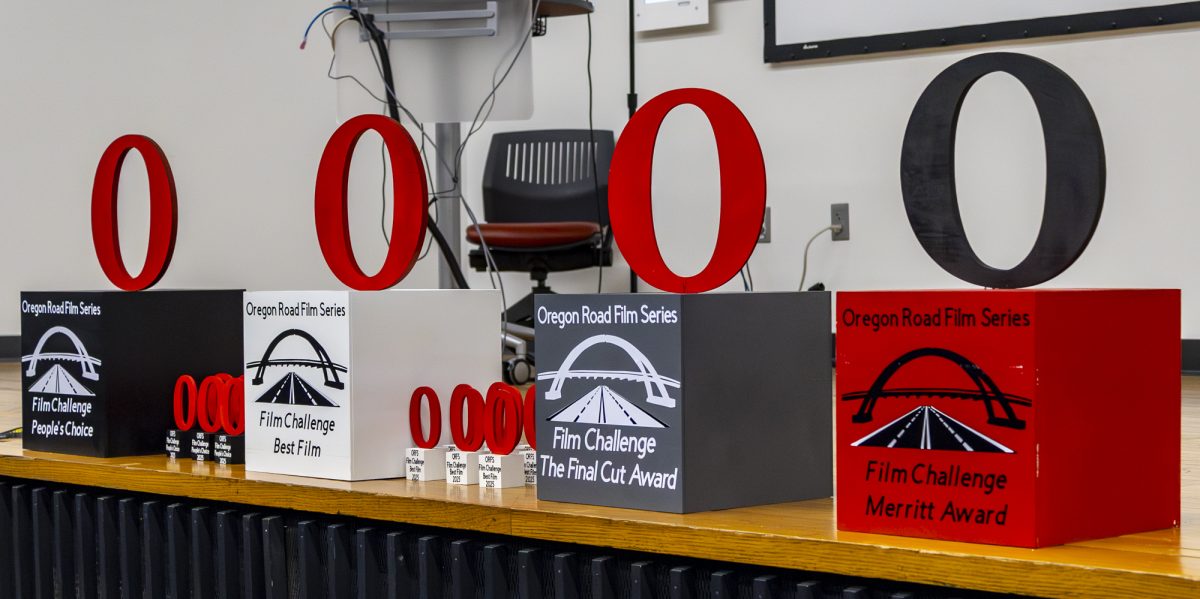 Oregon Road Film Challenge Awards lined up on the stage in CH 100, waiting for the winners. 