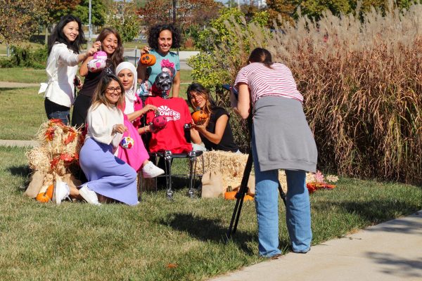 Lucas Sells Owens Students posing for an autumnal themed photo.